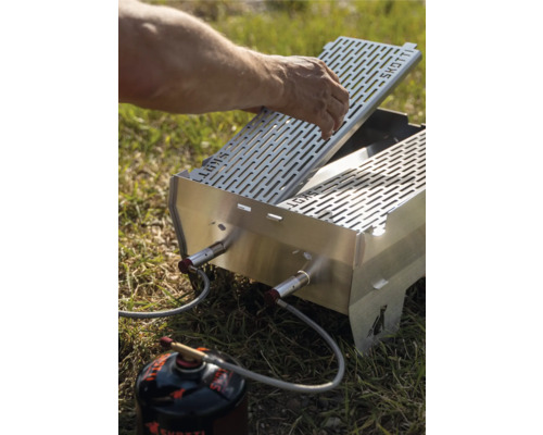 Gasgrill mit Grillrost und Gaskartusche im Freien