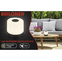Briloner Logo. LED-Tischleuchte für den Außenbereich auf einem Tisch. Schutzart IP44.