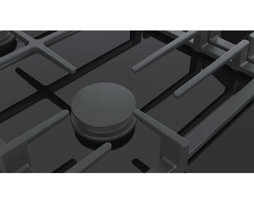 Detailansicht eines Gasherds mit Topfträger und Bedienknopf