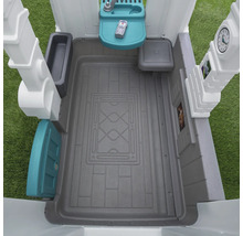 Innenansicht eines Spielhauses mit Spielküche, Spieltelefon und Zubehör