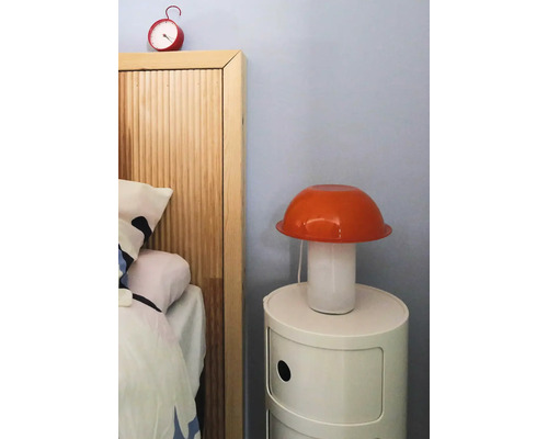 Schlafzimmer mit Nachttisch, Lampe und Wecker