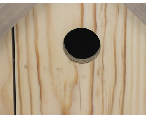 Detailansicht eines hölzernen Vogelhauses mit runder Öffnung