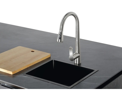 Küchenspüle mit Wasserhahn und Schneidebrett auf einer Arbeitsplatte