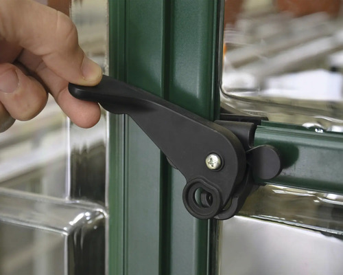 Detailaufnahme eines schwarzen Fenstergriffs an einem Fensterrahmen