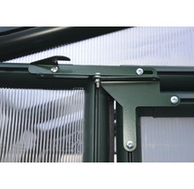 Detailansicht eines Gewächshausfensters mit Beschlägen und Schrauben.