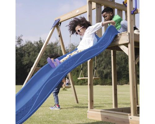 Kinder spielen auf einem Spielplatz mit Rutsche und Schaukeln