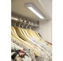 Kleiderschrank mit LED-Leuchte und Kleidung an Kleiderbügeln