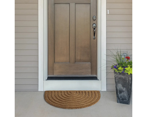 Halbkreisförmige Fußmatte vor einer Haustür