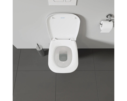 Aufnahme von oben einer Toilette mit offenem Toilettendeckel und Toilettenpapierhalter.