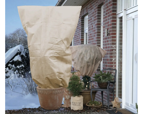 Winterliche Außenszene mit Pflanzen, die mit Pflanzenschutzvlies abgedeckt sind