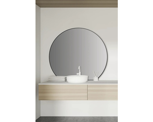 Modernes Badezimmer mit rundem Spiegel, Waschbecken und Holzunterschrank.