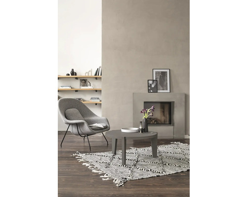 Wohnzimmer mit Sessel, Teppich, Couchtisch und Kamin