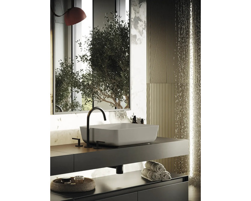 Modernes Badezimmer mit Waschbecken, Armatur, Spiegel und Handtüchern