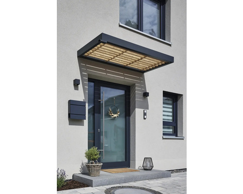 Haustür mit Vordach, Briefkasten und Dekoration an einer Hauswand