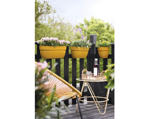 Außenaufnahme eines Balkons mit Blumenkästen, Stuhl und Tisch.