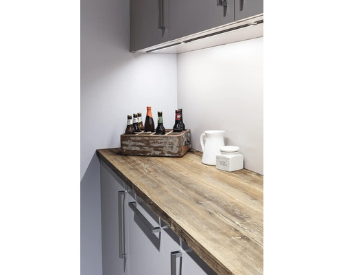 Küchenszene mit Arbeitsplatte in Holzoptik, Getränkekiste und Küchenutensilien