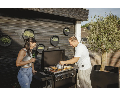 Szene mit einem Paar beim Grillen auf einem schwarzen Enders Gasgrill im Freien