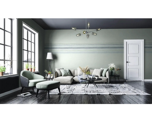 Wohnzimmer mit Sofa, Sessel, Teppich und Zimmerpflanzen in einem modernen Design.