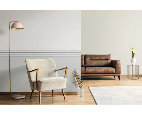 Wohnzimmer mit Sessel, Sofa, Stehlampe und Dekoration auf Holzboden