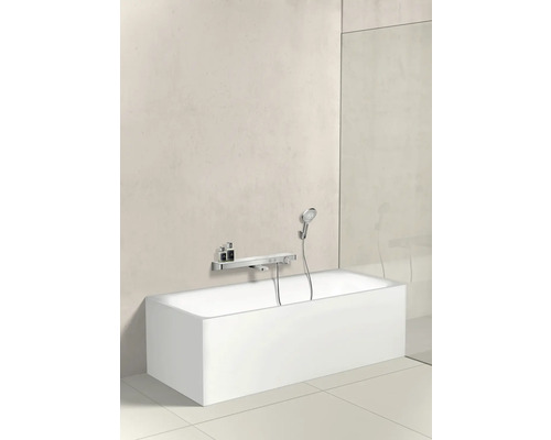Rechteckige Badewanne mit Armatur und Handbrause vor einer Wand