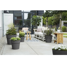 Terrasse mit bepflanzten Blumentöpfen und Sitzgelegenheiten im Freien