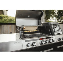 Edelstahl Grill mit Speisen in einer Form unter einem Grill