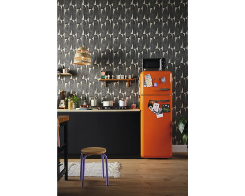Küchenszene mit einer schwarzen Küchenzeile, einem orangefarbenen Kühlschrank und einer gemusterten Tapete.