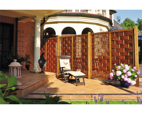 Terrasse mit Sichtschutzzaun aus Weide, Liegestuhl und Dekoration