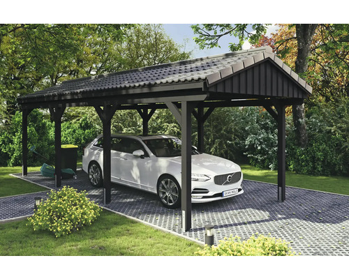 Einzelcarport SKAN HOLZ Fichtelberg inkl. Pfostenanker 317 x 808 cm anthrazit Carport mit Auto auf gepflastertem Untergrund im Garten.