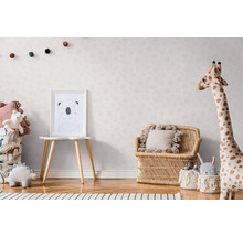 Kinderzimmer mit Möbeln und Dekorationen im skandinavischen Stil, darunter ein Bild, ein Sitzmöbel und Spielzeuge.