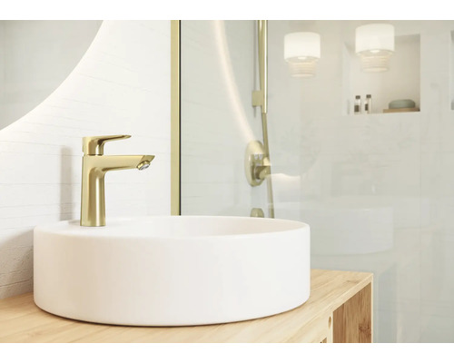 Aufsatzwaschbecken mit goldener Waschtischarmatur in hellem Badezimmer.