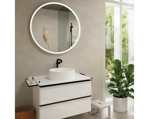 Modernes Badezimmer mit rundem Spiegel, Waschtisch und Zimmerpflanze