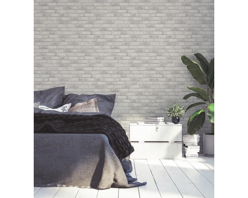 Schlafzimmer mit Backsteinmauer-Tapete, Bett und Pflanzen