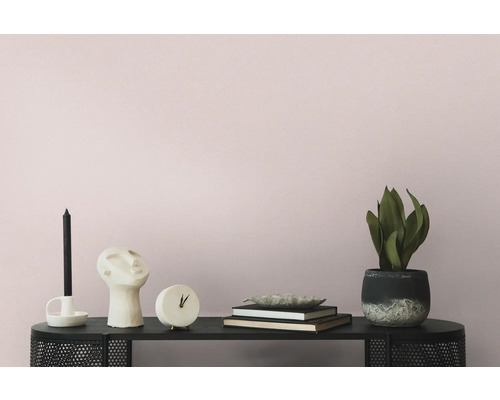 Dekorative Szene mit Kerze, Skulptur, Uhr, Büchern und Topfpflanze auf einem schwarzen Regal