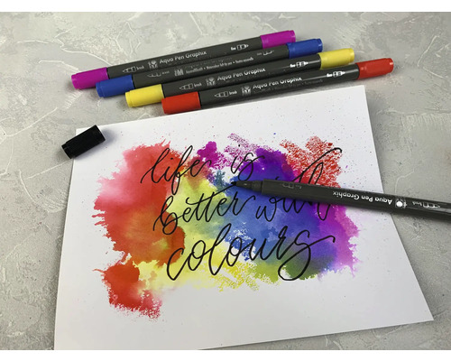 Aquarellstifte mit Aquarellfarben und dem Schriftzug ''Life is better with colours'' auf Papier