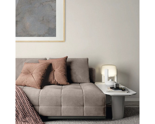 Wohnzimmer mit Sofa, Kissen und Beistelltisch mit Lampe