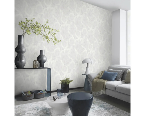 Heller Wohnraum mit gemusterter Tapete, Sofa und Dekorationen.