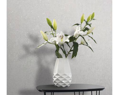 Vase mit Lilienblüten auf einem Tisch