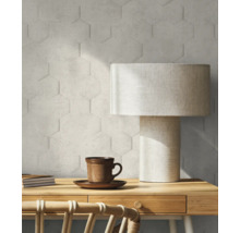 Nahaufnahme eines Arbeitszimmers mit Sechseck-Wandfliesen, Tischleuchte, Holzschreibtisch, Stuhl, Notizblock und Kaffeetasse