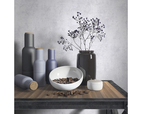 Dekoratives Stillleben mit Vasen, Schale und Pflanzen auf einem Tisch.