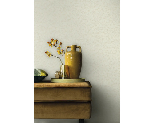 Szene mit einem beigen Wandhintergrund, einem beigen Samtsofa, einem Tablett, Vasen und einer Blume