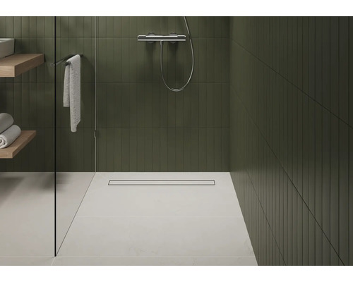 Badezimmer mit Dusche, Duschrinne, Handtüchern und Regalen