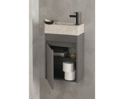 Grauer Waschtisch mit offenem Schrank, Armatur und Ablagefläche im Badezimmer.