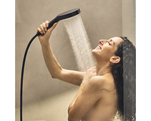 Frau unter der Dusche mit Handbrause und Duschschlauch