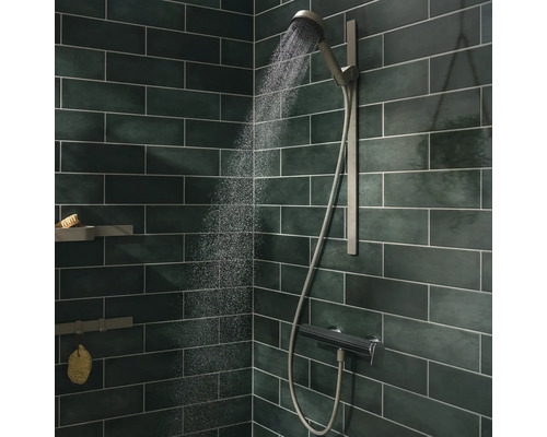 Badezimmerdusche mit Handbrause, Brausestange und Thermostat vor gefliester Wand