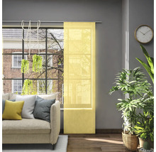 Wohnzimmer mit Schiebevorhang am Fenster, Sofa, Zimmerpflanzen und Wanduhr