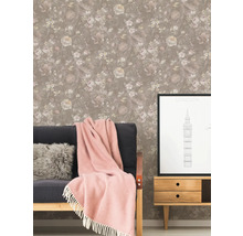 Wohnzimmer mit floral gemusterter Tapete, Sofa und Kommode