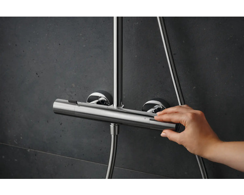 Aufnahme einer Hand, die einen Duschthermostat aus Metall bedient