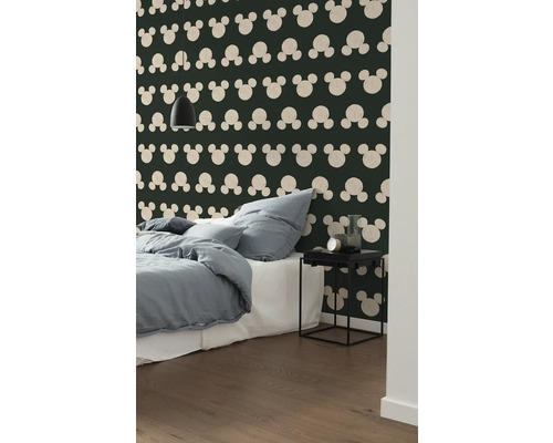 Schlafzimmer mit Bett, Nachttisch und Wandtapete mit Mickey Maus Motiv