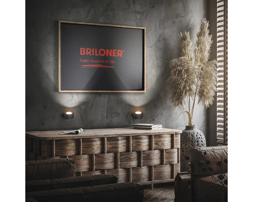 Wohnzimmer mit Kommode, Wandleuchten und Briloner Logo auf einem Bild